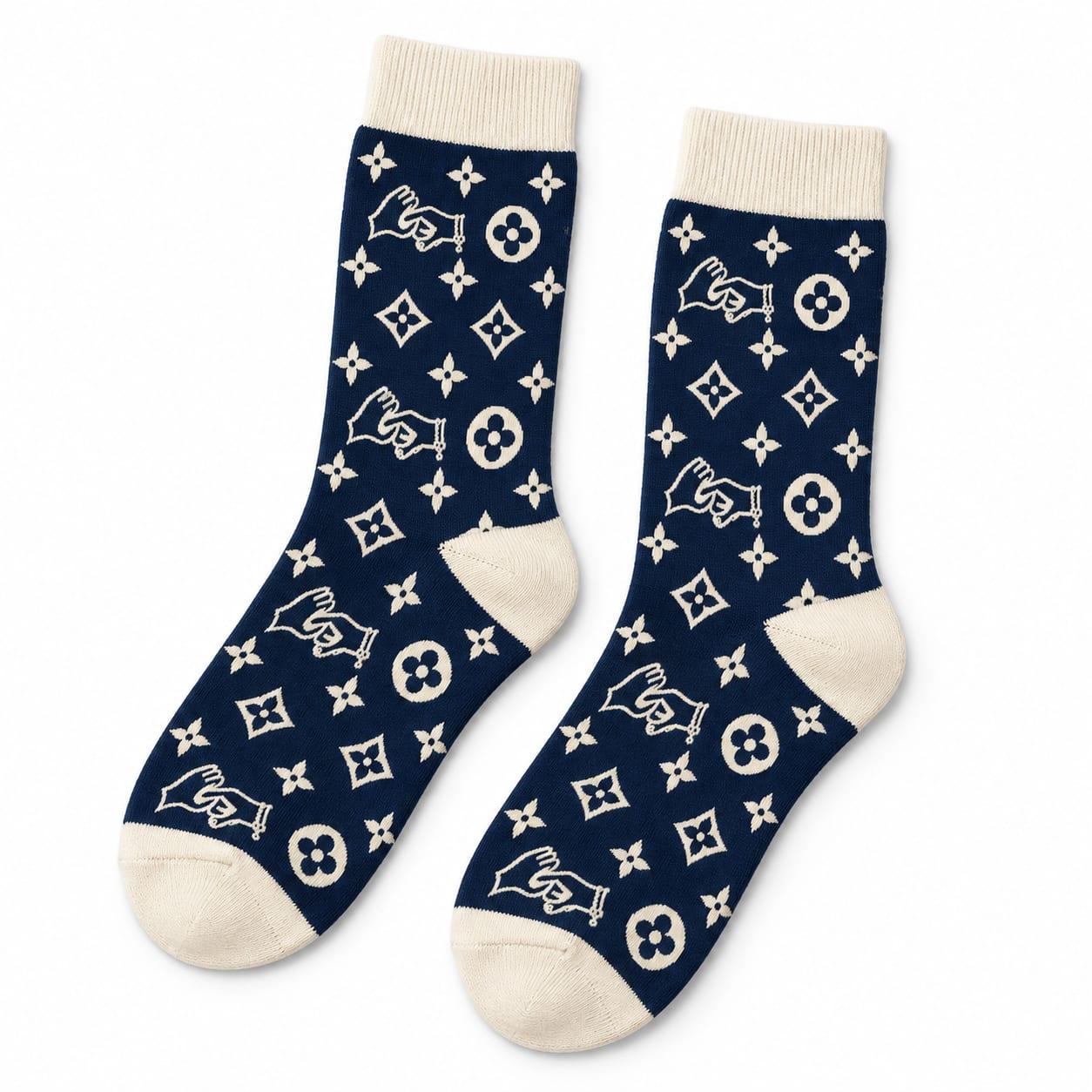 Pair of navy crew socks with the cream hands monogram and cream heels and toes
